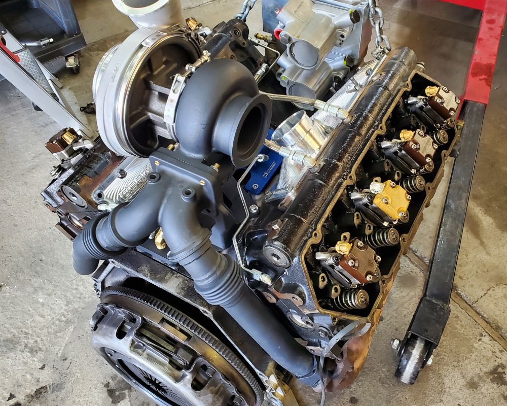 Diesel engine and turbocharger on a hoist inside the BPE workshop in Bend.